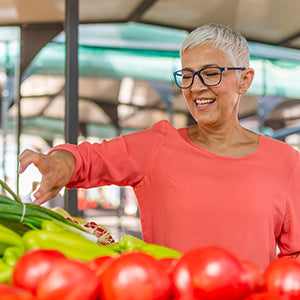 Woman getting various types of vegetables