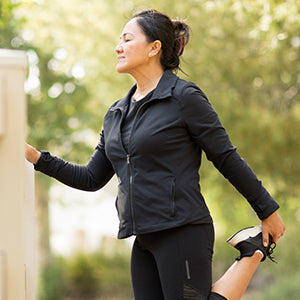 Woman stretching for a run in a natural background.