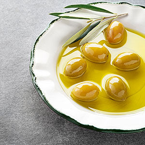 A dish of olives in olive oil.