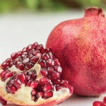 Two pomegranates on a counter. The benefits of pomegranates come from the high nutritional profiles of its antioxidants