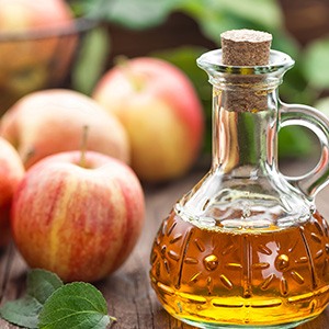 A bottle of apple cider vinegar is a great remedy for reducing bloating naturally.