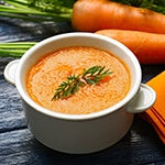 A bowl of carrot soup with goji, orange, and ginger. Oranges and goji berries are a great source of vitamin C and beta-carotene.