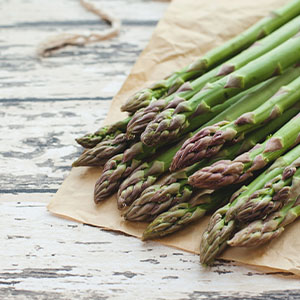 A plate of asparagus, which is a food that can cause flatulence.