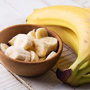 A bowl of sliced banana. There are many simple things you can do to keep your digestive system healthy like eating well.