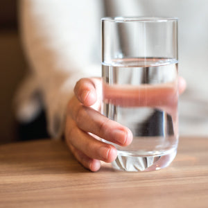 A glass full of water. There are many benefits that come from fasting for weight loss.