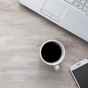 A laptop on a desk. A healthy workplace during winter is about having healthy work habits and avoiding germs and microbes.