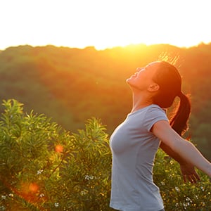 A woman staring at the sun. Lipase helps boost the immune function.