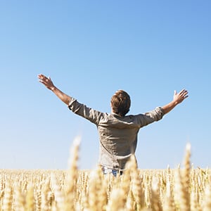 An individual in the middle of a field. Exercising is part of the lung cleansing process.