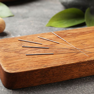 A board with acupuncture needles.