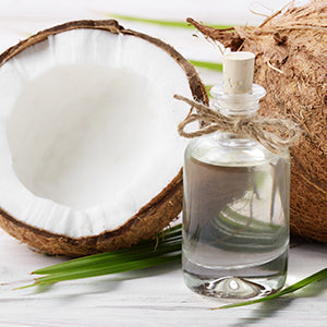 A bottle of MCT oil and coconuts.