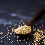 A spoon full of mustard seeds which are considered a superfood loaded with many nutrients that support good health.