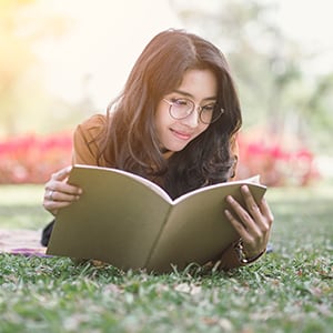 A woman studying in the park.