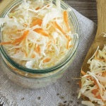 A jar of organic sauerkraut. A specific probiotic strain called Lactobacillus rhamnosus may help fight lactose intolerance.