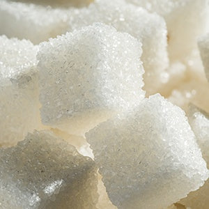 Stack of sugar cubes. Drinks like sodas and energy drinks contain a lot of refined sugar that can lead to obesity.