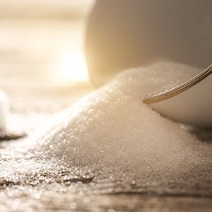 Stack of sugar cubes. Drinks like sodas and energy drinks contain a lot of refined sugar that can lead to obesity.