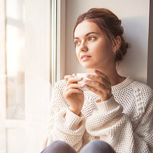 A woman drinking herbal tea.