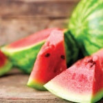 A watermelon salad is a nutritious and perfect snack for the summer. Watermelon cubes on a wooden table.